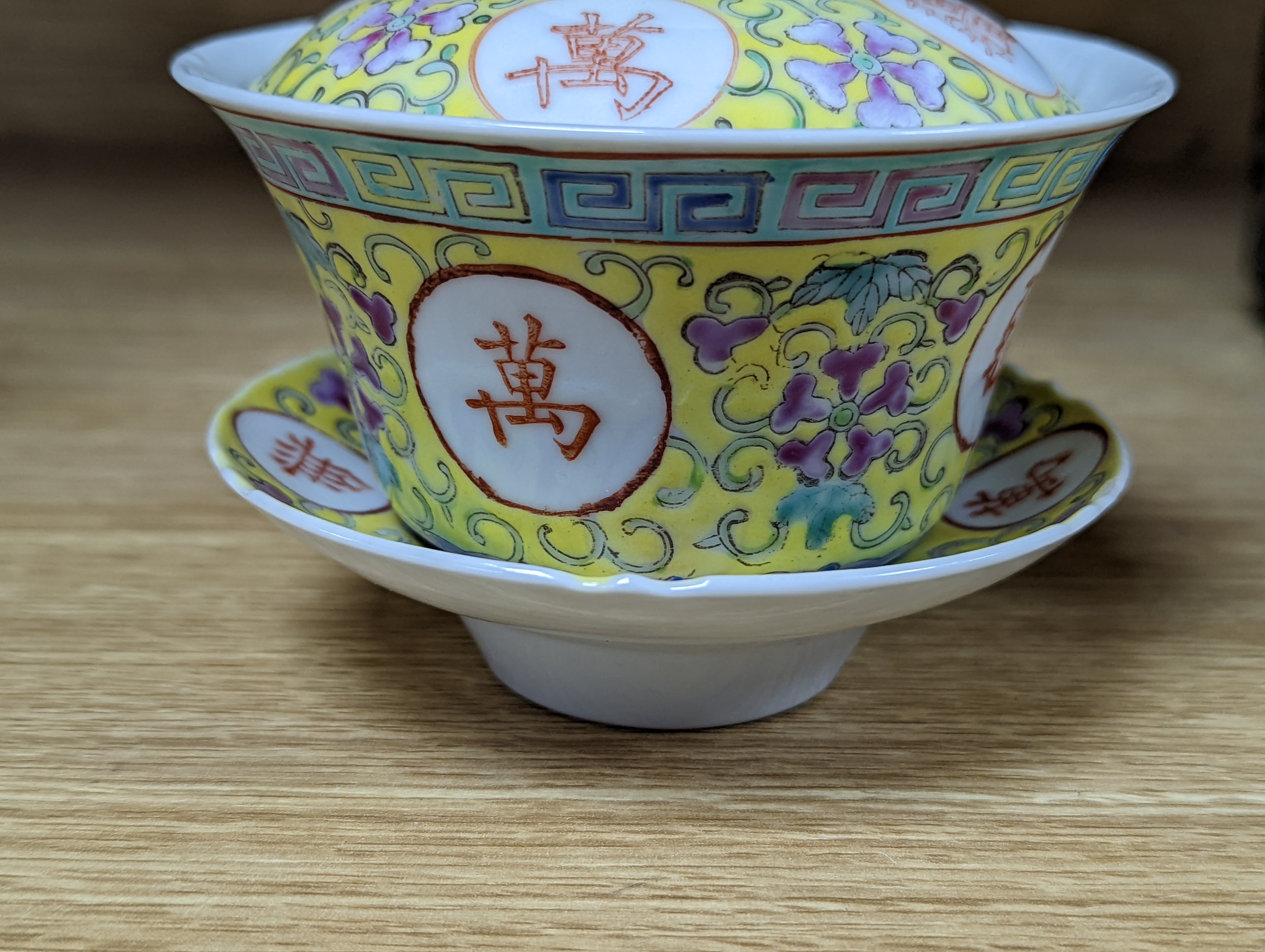 A pair of Chinese enamelled porcelain rice bowls, covers and stands and an odd bowl